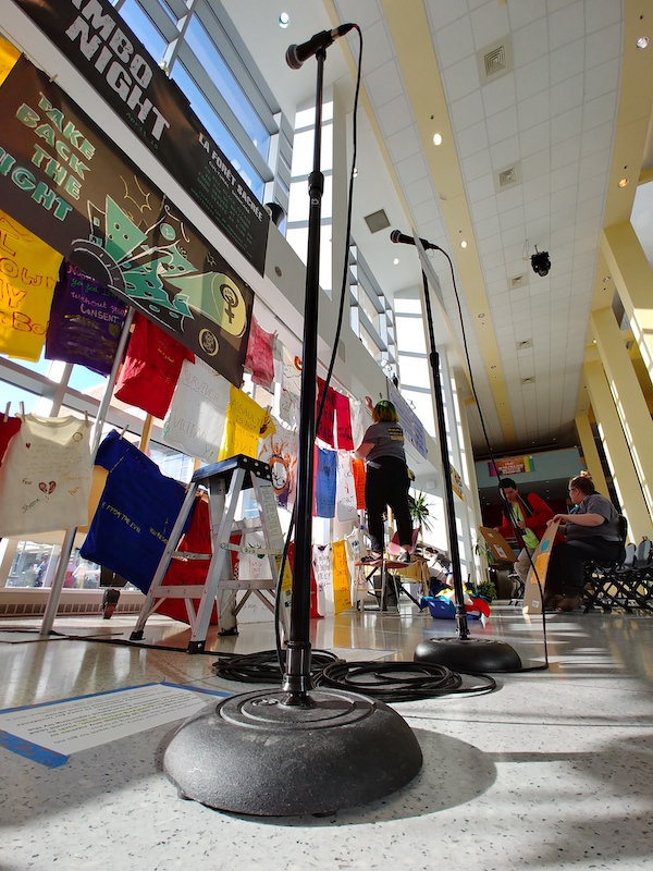 A microphone in front of the Clothesline Project